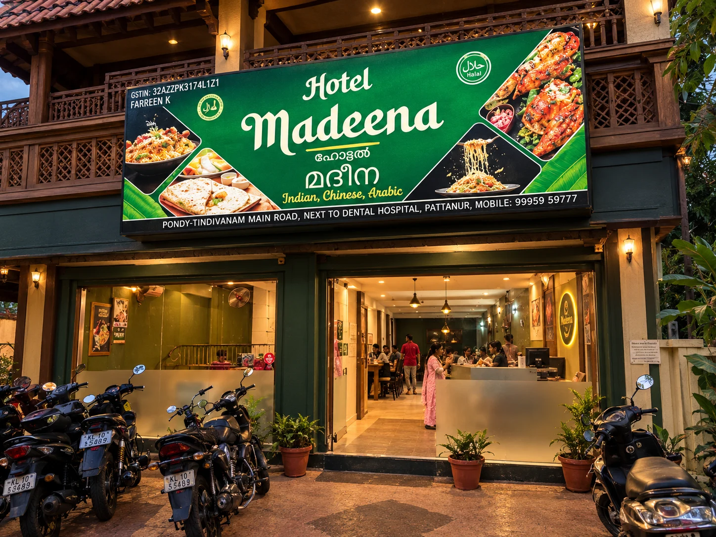 Front of Hotel Madeena, showing the green signboard and restaurant entrance